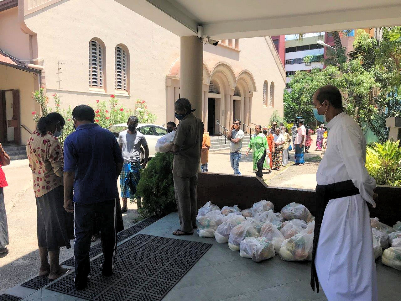 Father Dilan supervising the distribution of your care packages on Tuesday 7/4/20